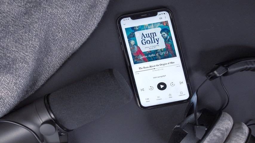 Image of an audiobook with headphones, black phone and microphone on black background and different shades of gray. Used to illustrate  an article on Becoming an Audiobook Narrator: A Step-by-Step Guide. Photo by Jukka Aalho on Unsplash: https://unsplash.com/photos/lPAaFIVHvH0
