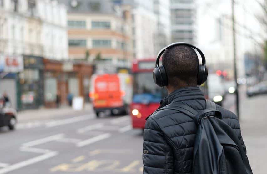 Photo of a man wearing headphones to illustrate the article “PFH Meaning for Audiobooks and Voice Over Work”.  Unsplash license: https://unsplash.com/photos/bAFiBDMeiVI