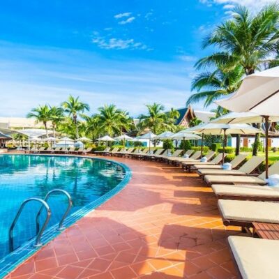 Hotel Sample Script. Photo hammocks and umbrella placed near to a large pool. This image is used to illustrate the article “Hotel Sample Script for Commercial Voice Over.” Freepik license: https://www.freepik.com/free-photo/hammocks-umbrella-placed-near-large-pool_950051.htm